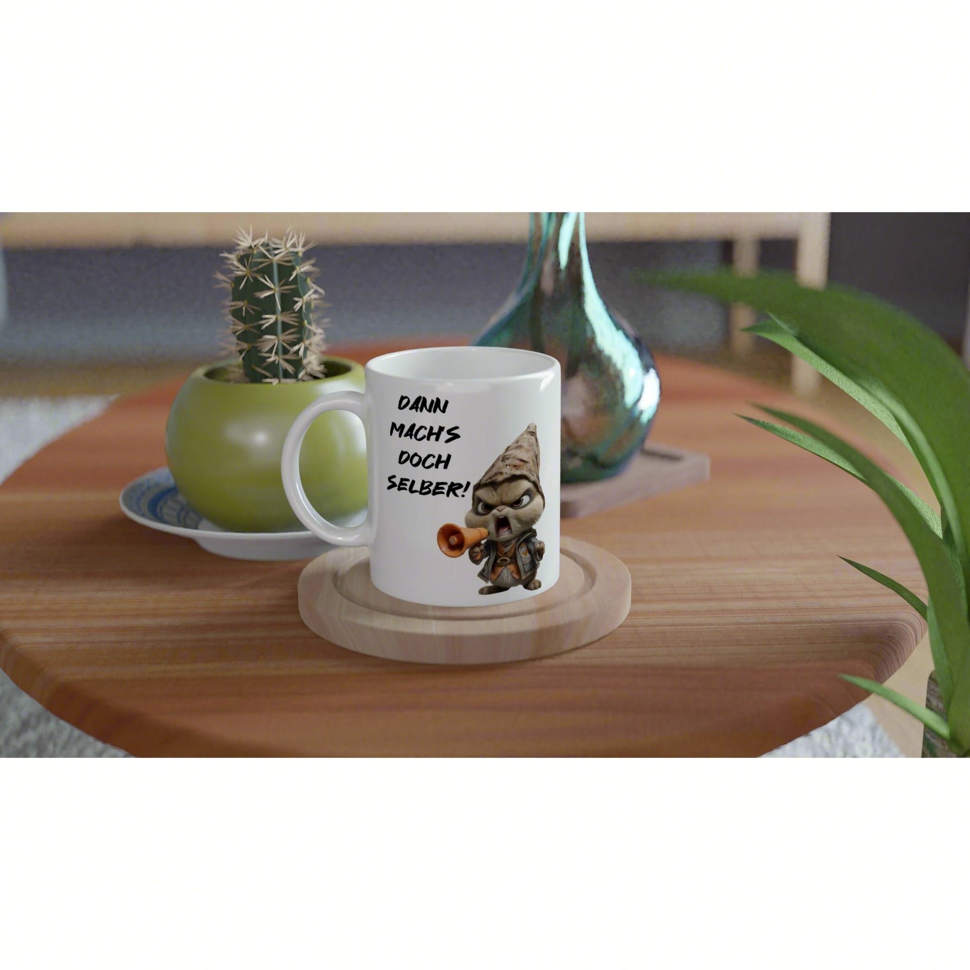 Product mockup: white mug with cartoon gnome and slogan 'Dann mach's doch selber!', on a wooden coaster beside plants.