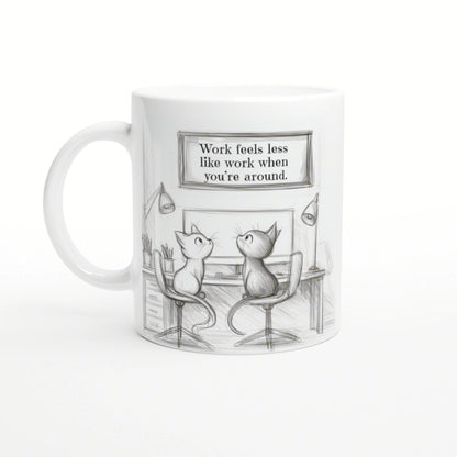 Sketch-style mug featuring two cats at a desk with a framed quote: 'Work feels less like work when you're around'.