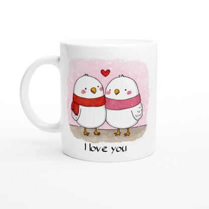 Mockup mug depicting two white birds in scarves on a pink background with the caption 'I love you'.