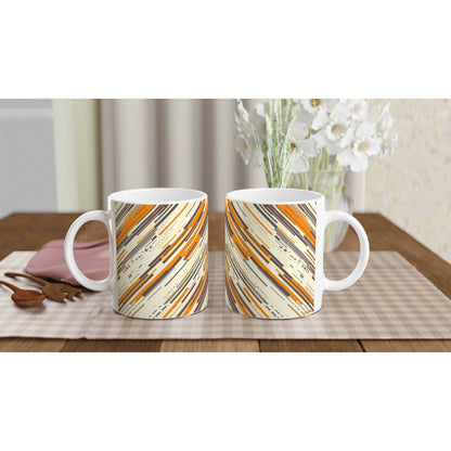 Two ceramic mugs with orange, beige, and black diagonal stripe pattern; product mockup on a wooden table.