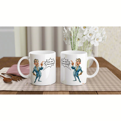 Two white ceramic mugs featuring a cartoon man shouting 'Ende der Diskussion' on a checkered placemat; product mockup.