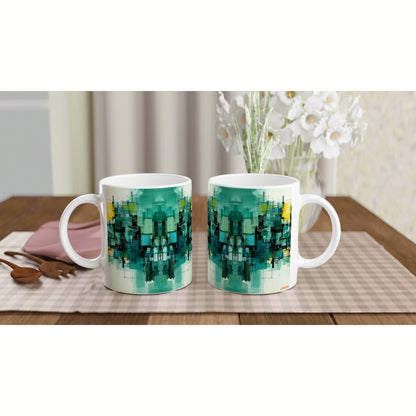 Two white ceramic mugs with teal-green geometric abstract print on a wooden table, blurred white flowers in the background.