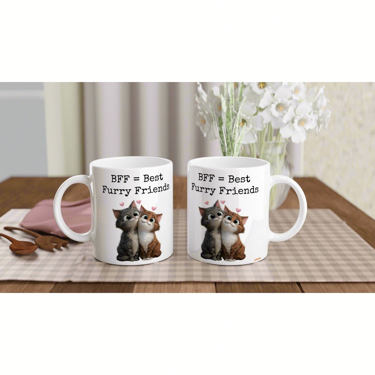 Two white mugs on a wooden table with a checkered placemat, 'BFF = Best Furry Friends' featuring cuddling cats and hearts.