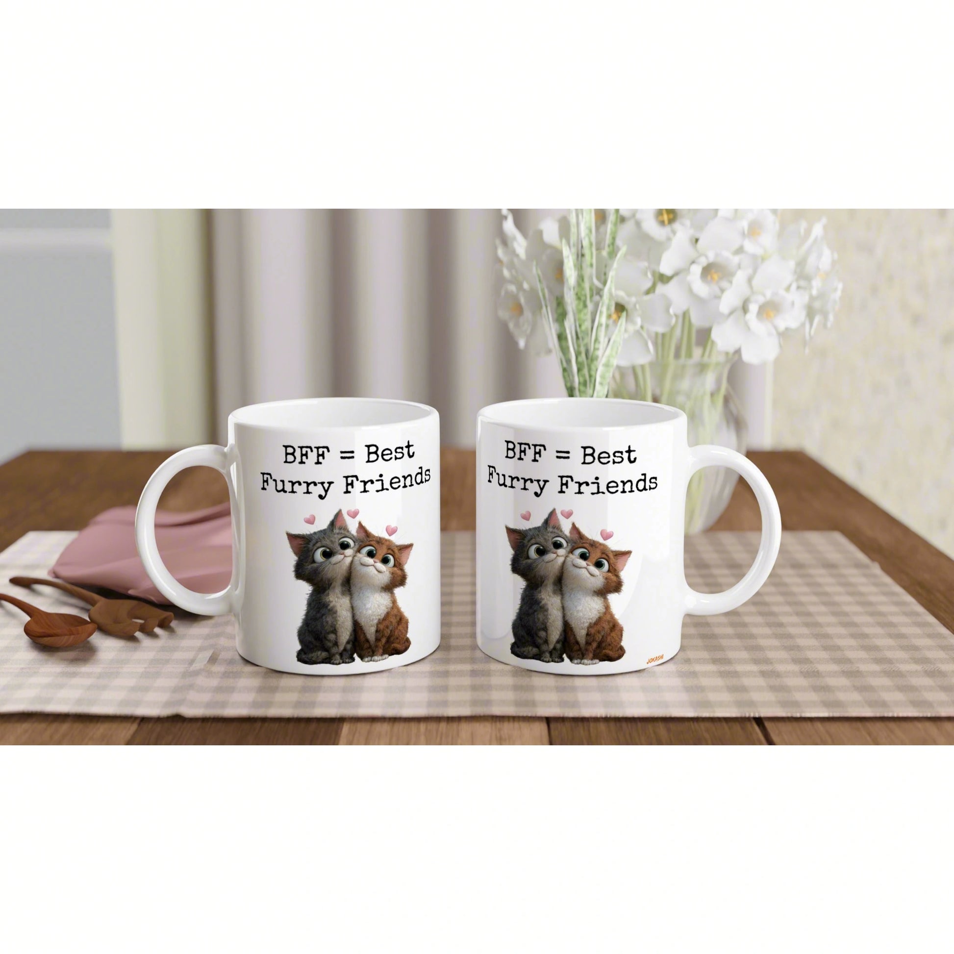 Two white mugs on a wooden table with a checkered placemat, 'BFF = Best Furry Friends' featuring cuddling cats and hearts.