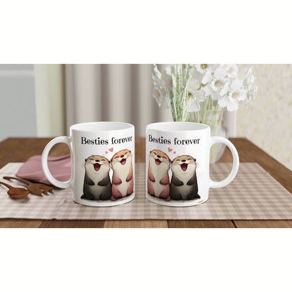 Two white mugs with cartoon otters and the text Besties forever on a wooden table (product mockup).