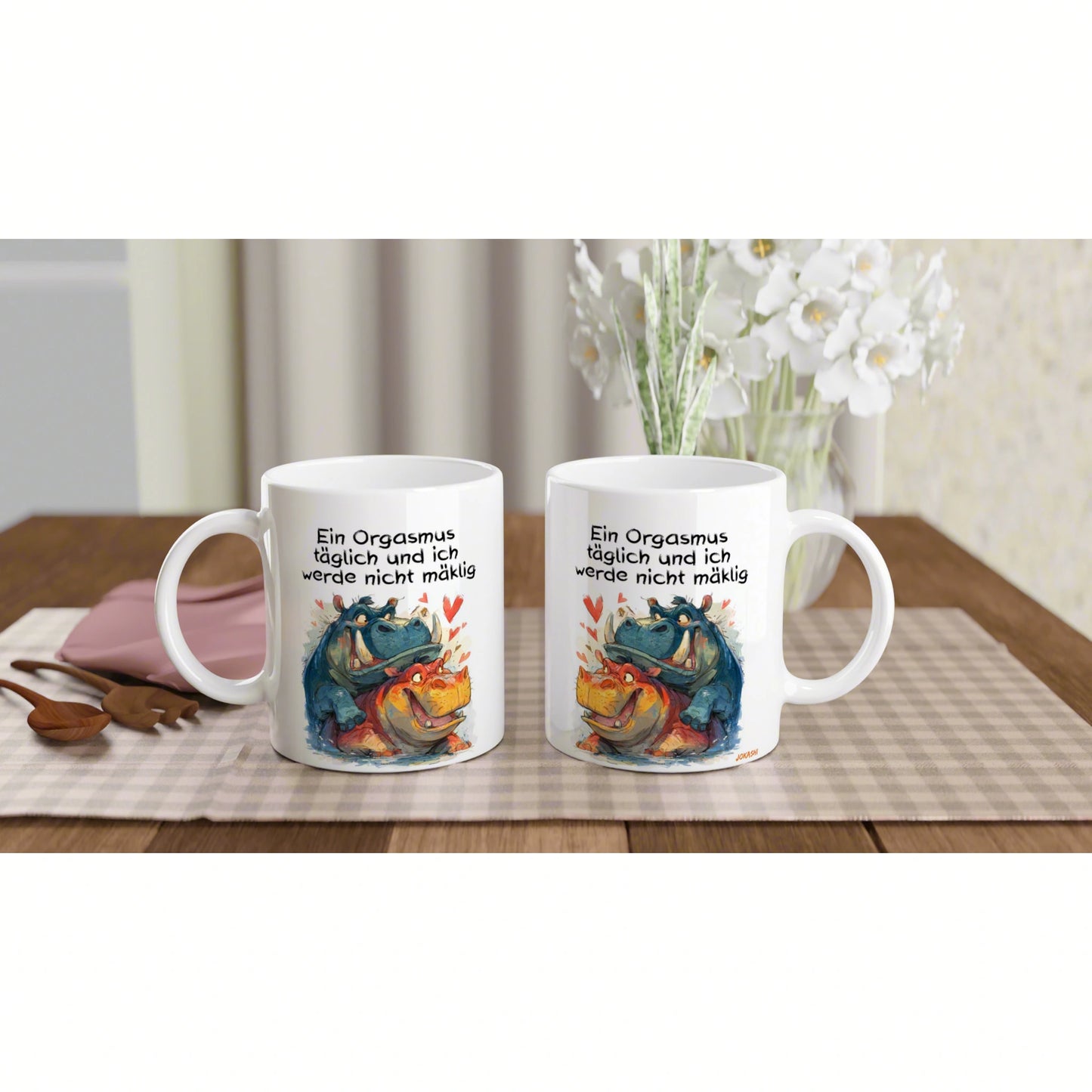 Two white mugs on a wooden table with a colorful dragon illustration and a German humorous slogan.
