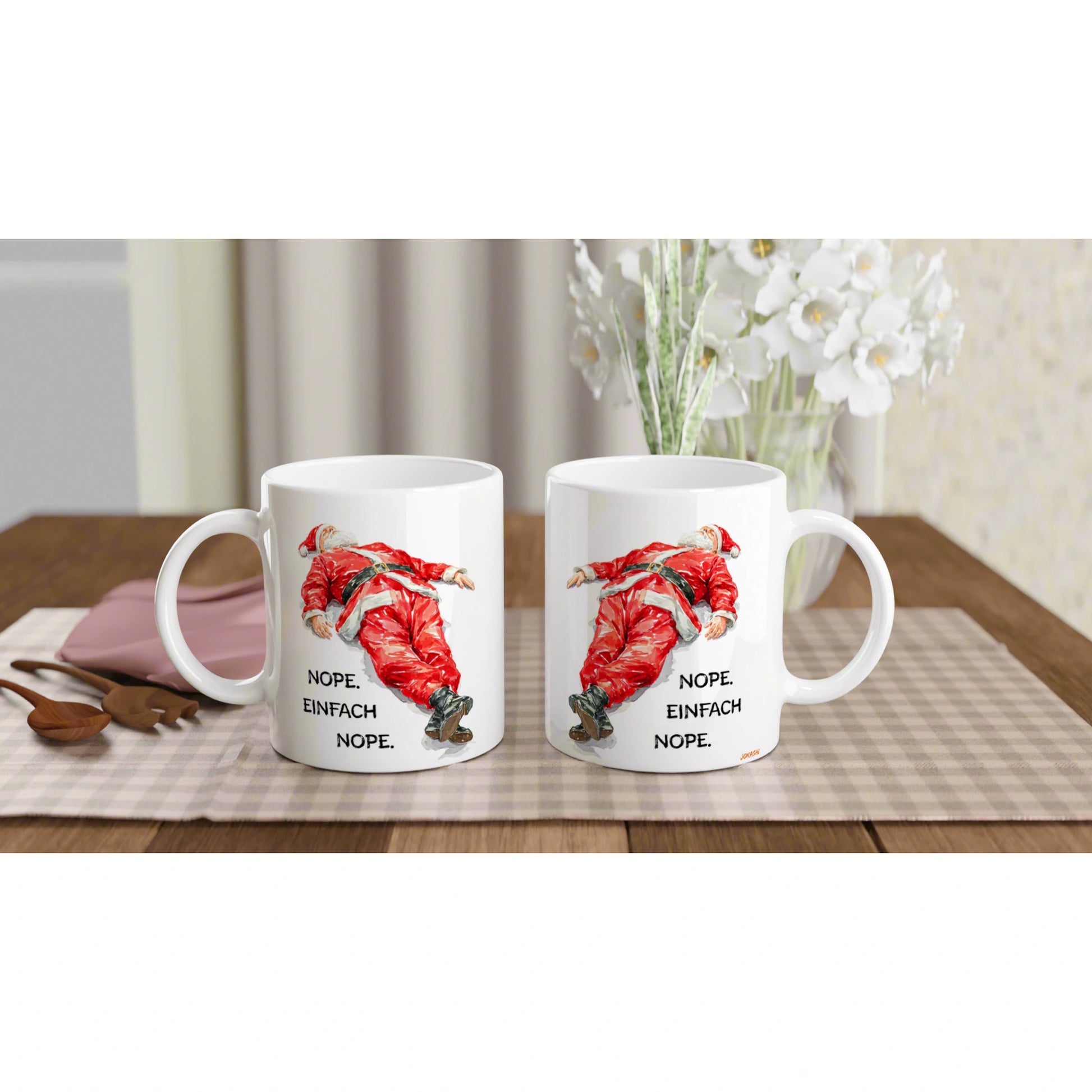 Two white mugs on a wooden table feature a red Santa illustration and the caption 'NOPE. EINFACH NOPE.' — product mockup.