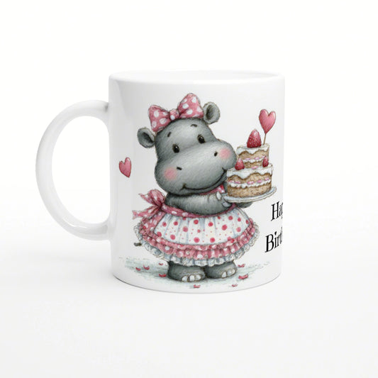 Whimsical hippo in a pink polka-dot dress and bow, holding a layered cake on a white mug.
