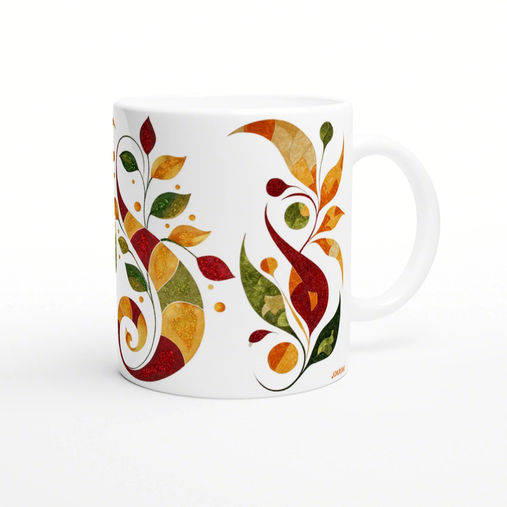 White ceramic mug featuring a vibrant abstract autumn leaf pattern in red, orange, yellow, and green.