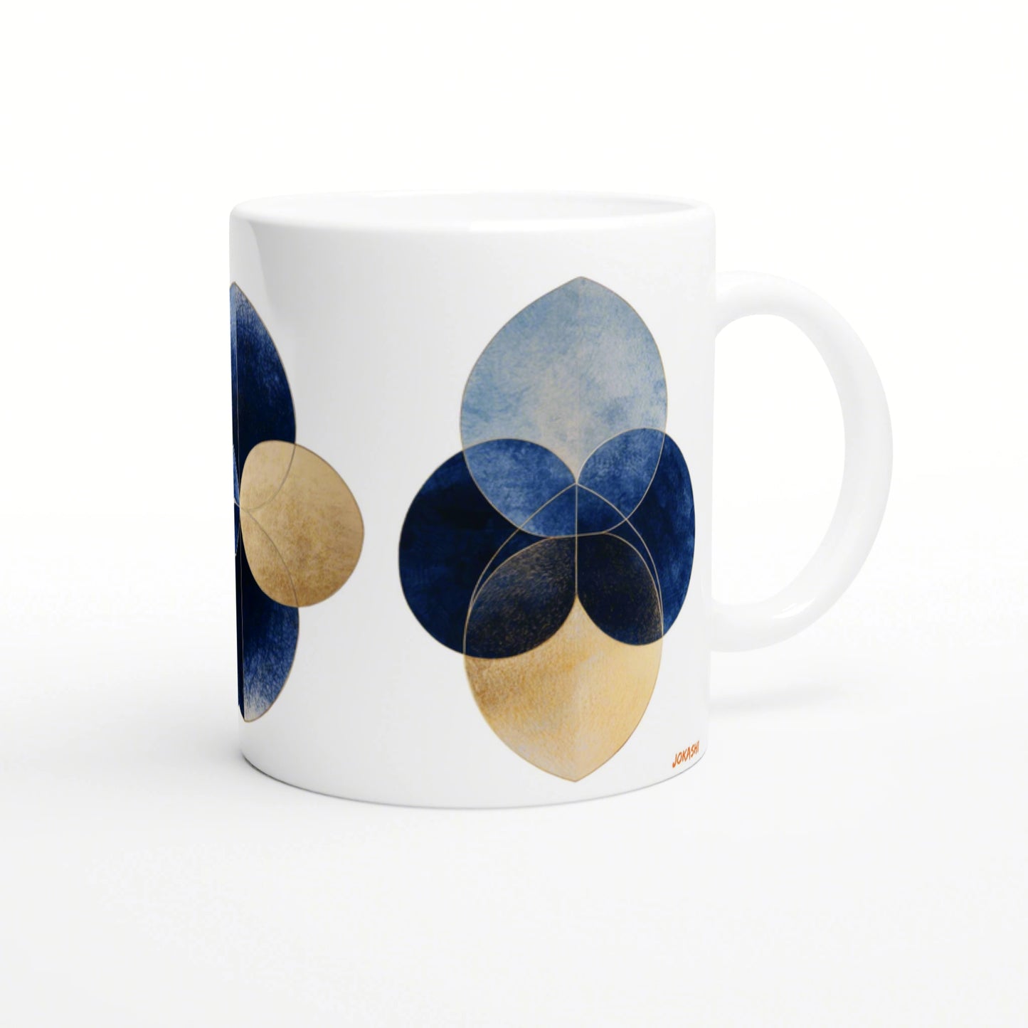 White ceramic mug mockup featuring an abstract geometric flower: overlapping blue and gold circular petals.