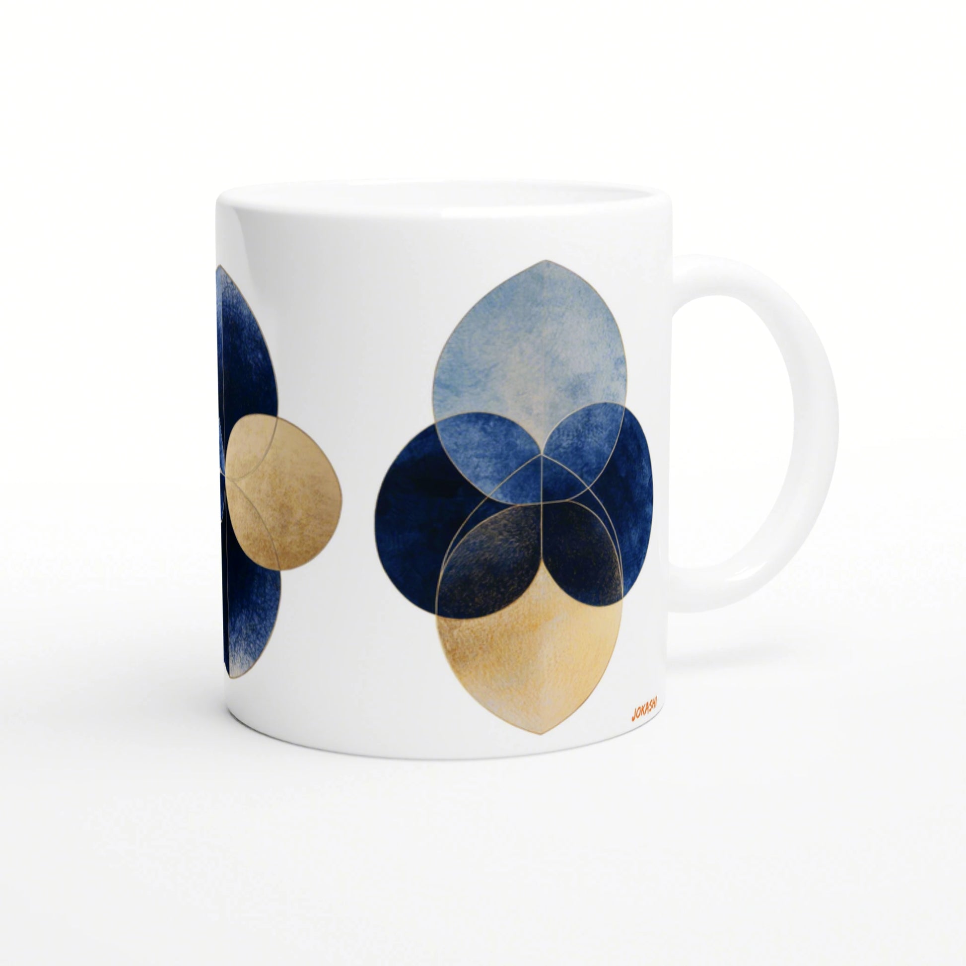 White ceramic mug mockup featuring an abstract geometric flower: overlapping blue and gold circular petals.