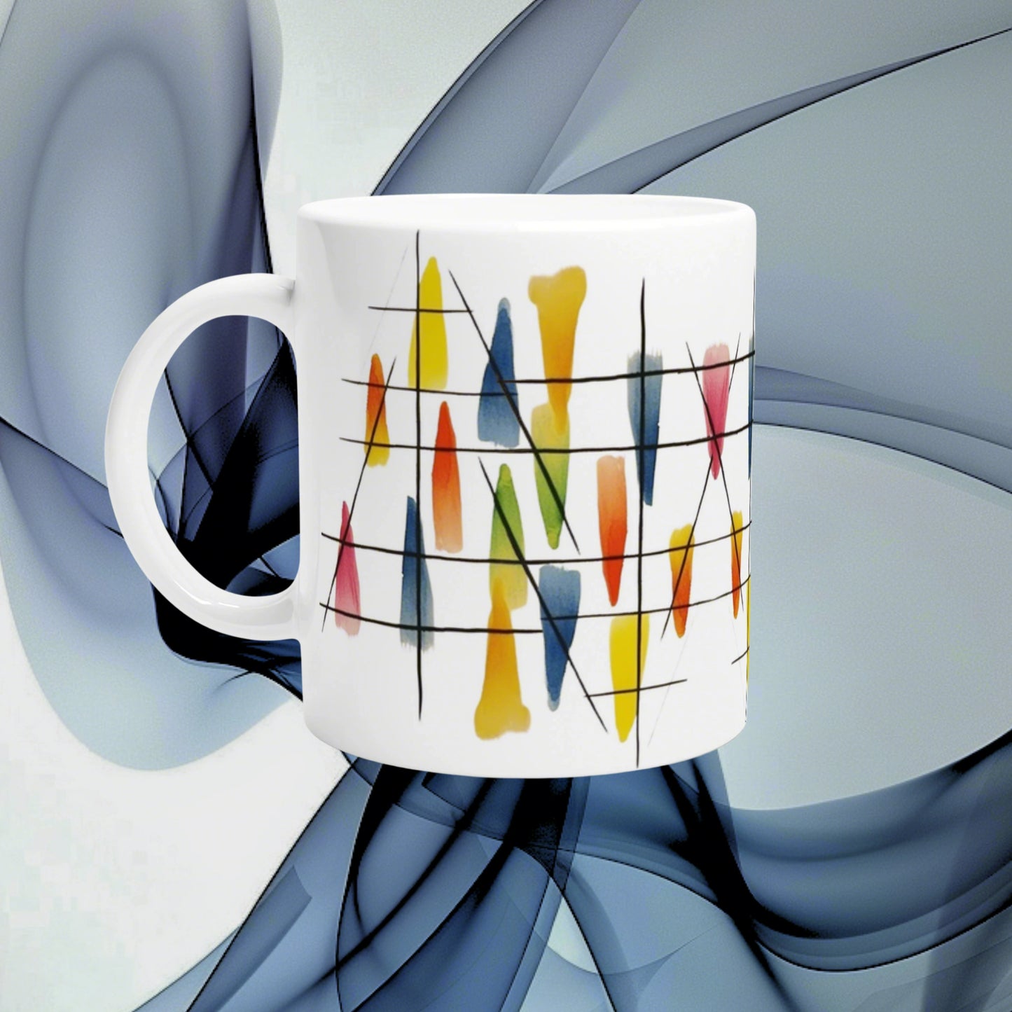 White ceramic mug with abstract colorful brush-stroke pattern and black lines, shown as a product mockup on a blue background.