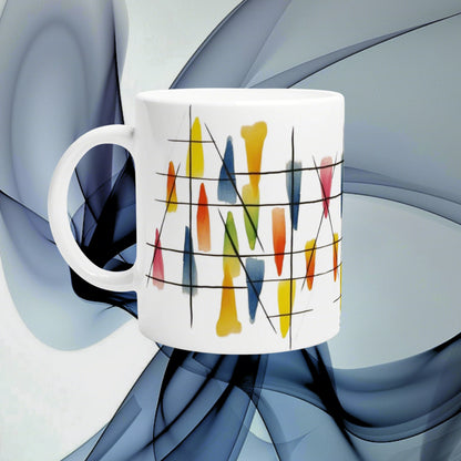 White ceramic mug with abstract colorful brush-stroke pattern and black lines, shown as a product mockup on a blue background.