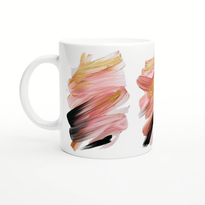 White ceramic mug featuring abstract brushstroke artwork in pink, peach, gold, and black.
