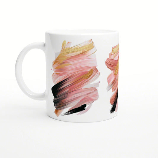 White ceramic mug featuring abstract brushstroke artwork in pink, peach, gold, and black.