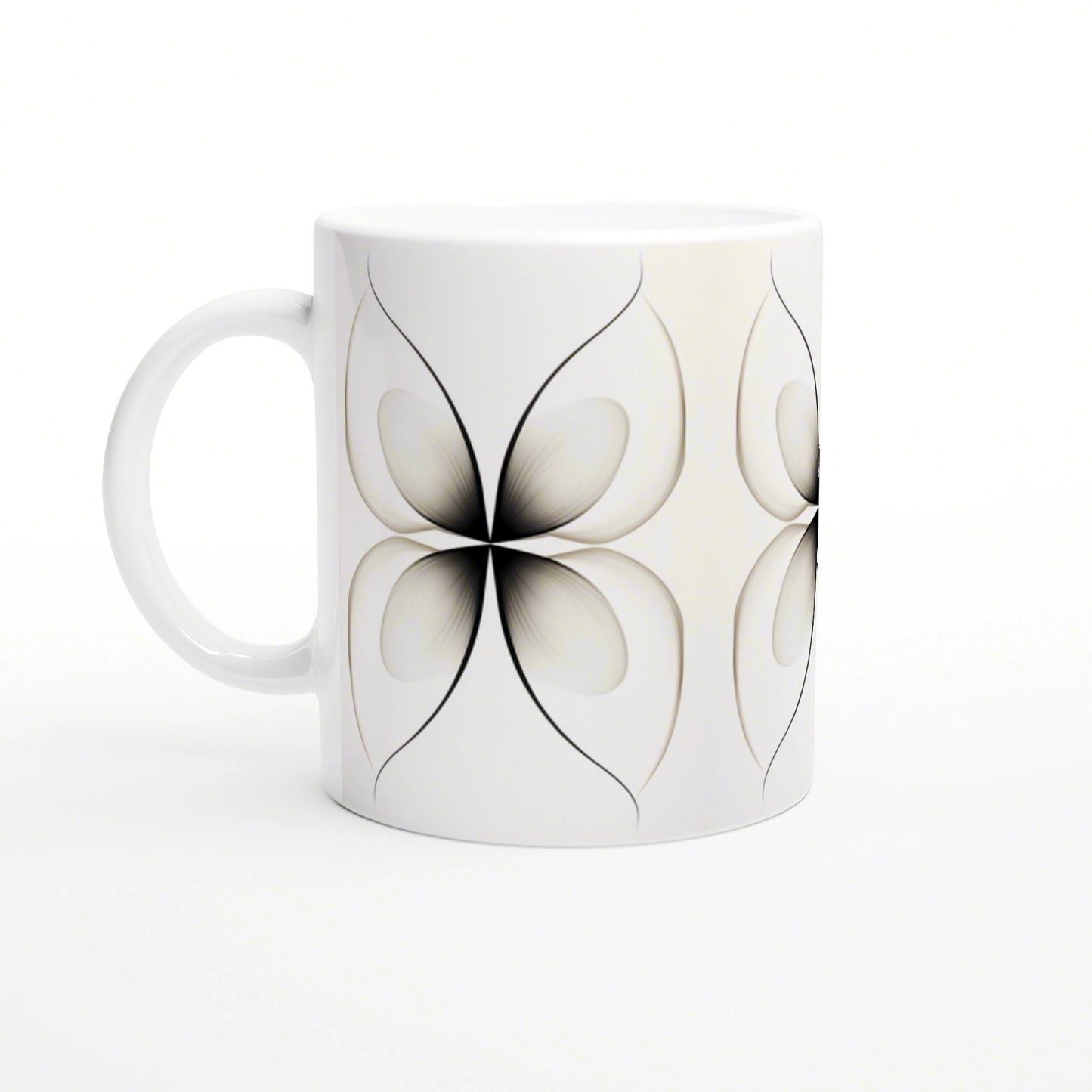 White ceramic mug with a repeating black abstract flower petal motif on a light background, product mockup.