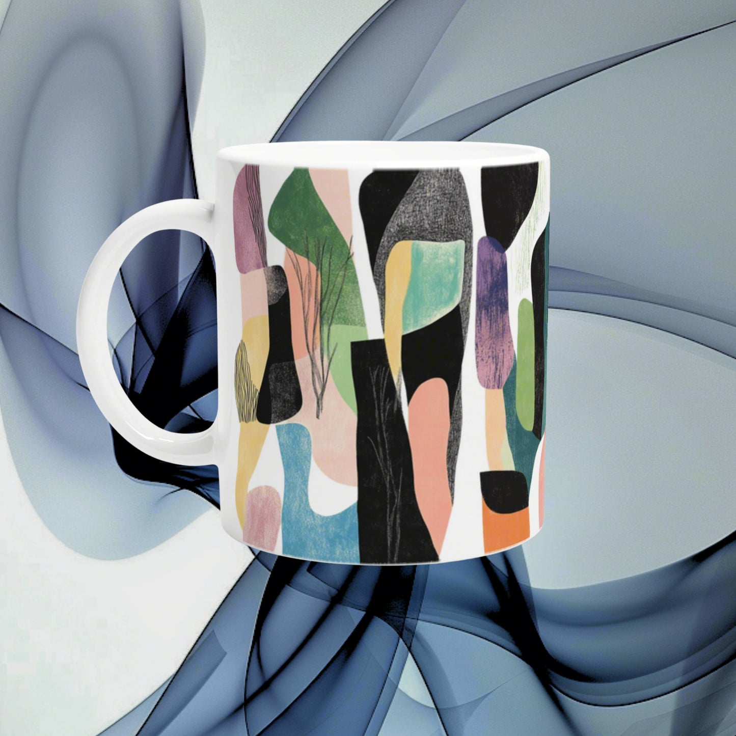 White ceramic mug with a vibrant abstract pattern of multicolored shapes; product mockup for an online shop.