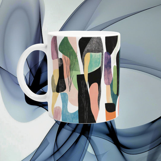 White ceramic mug with a vibrant abstract pattern of multicolored shapes; product mockup for an online shop.