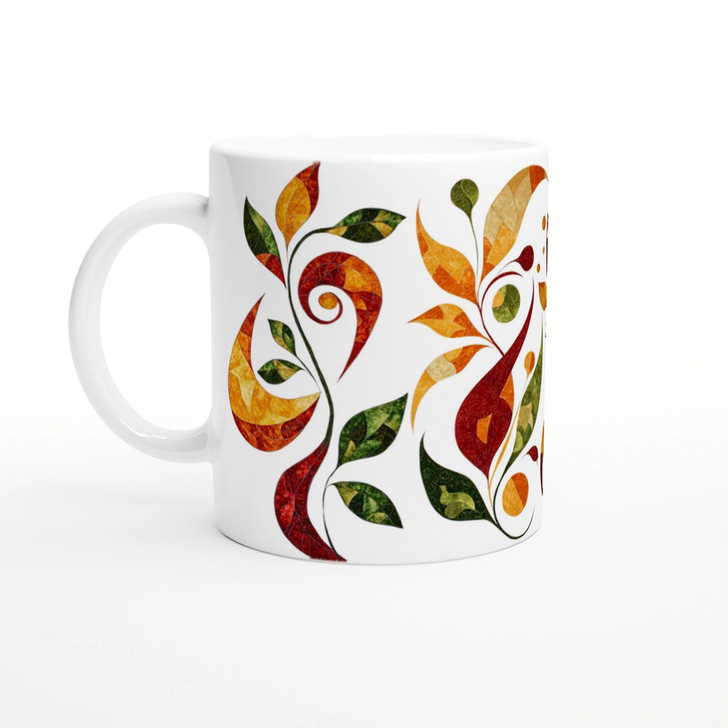 White ceramic mug decorated with a vivid abstract vine design of orange, red, yellow and green leaves wrapping around.