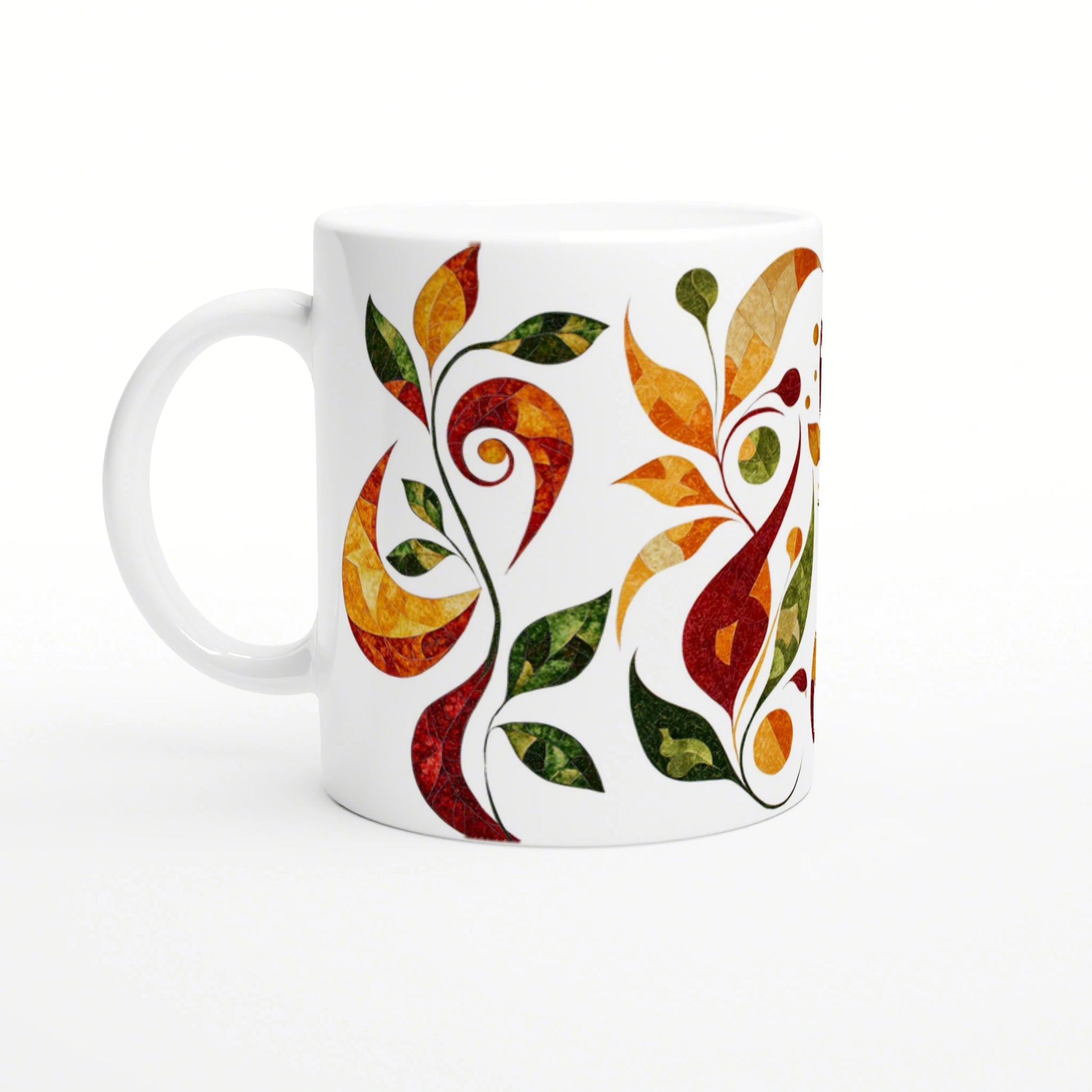 White ceramic mug decorated with a vivid abstract vine design of orange, red, yellow and green leaves wrapping around.