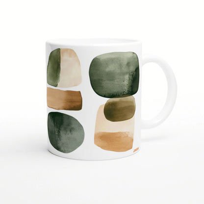 White ceramic mug with abstract watercolor blocks in green, beige and brown on its surface.