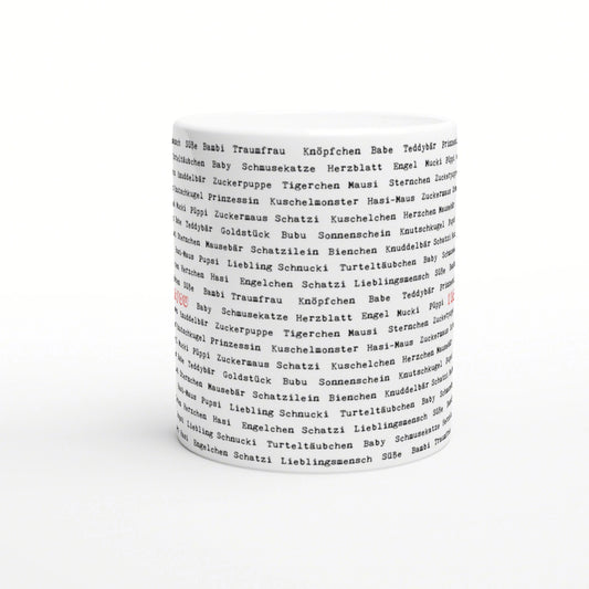White ceramic mug with an all-over print of German endearment words in black, shown as a product mockup for slogan mugs.