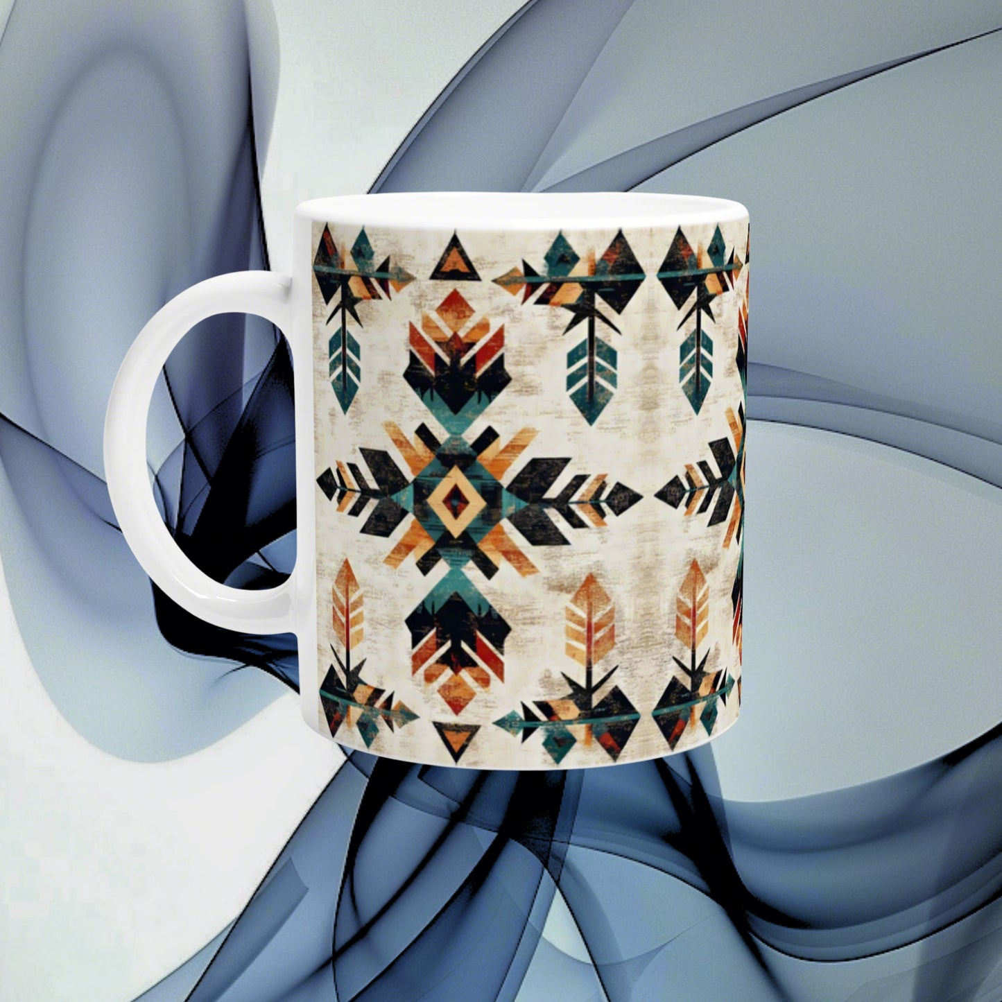 White ceramic mug with a beige background featuring a colorful geometric Aztec-inspired pattern; product mockup.