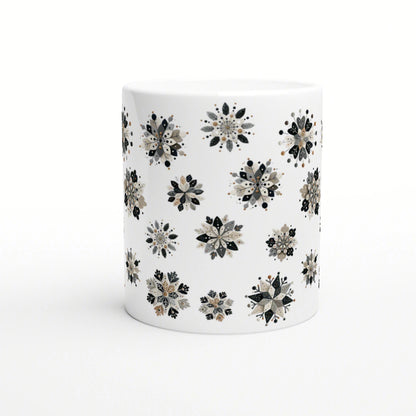 White ceramic mug with a repeating black, gray and beige floral snowflake pattern; product mockup.