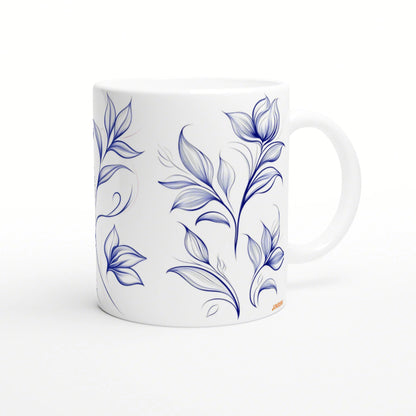 White ceramic mug with a blue botanical floral pattern wrapping around the surface.
