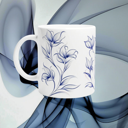 White ceramic mug with blue floral pattern shown as a product mockup against abstract blue background.