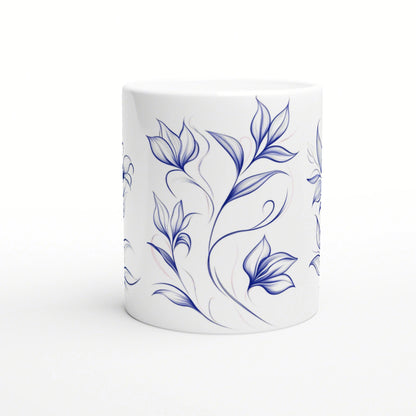 White ceramic mug with a blue hand-drawn floral vine pattern wrapping around.