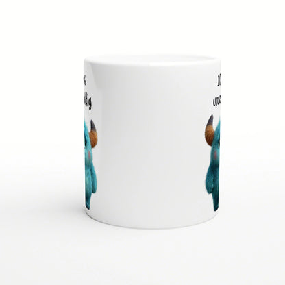 White ceramic mug featuring blue fluffy monsters with brown horns peeking from the sides; product mockup for humorous slogans.