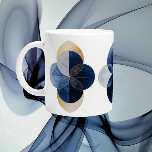 White ceramic mug with blue geometric four-leaf clover motifs against an abstract blue background.