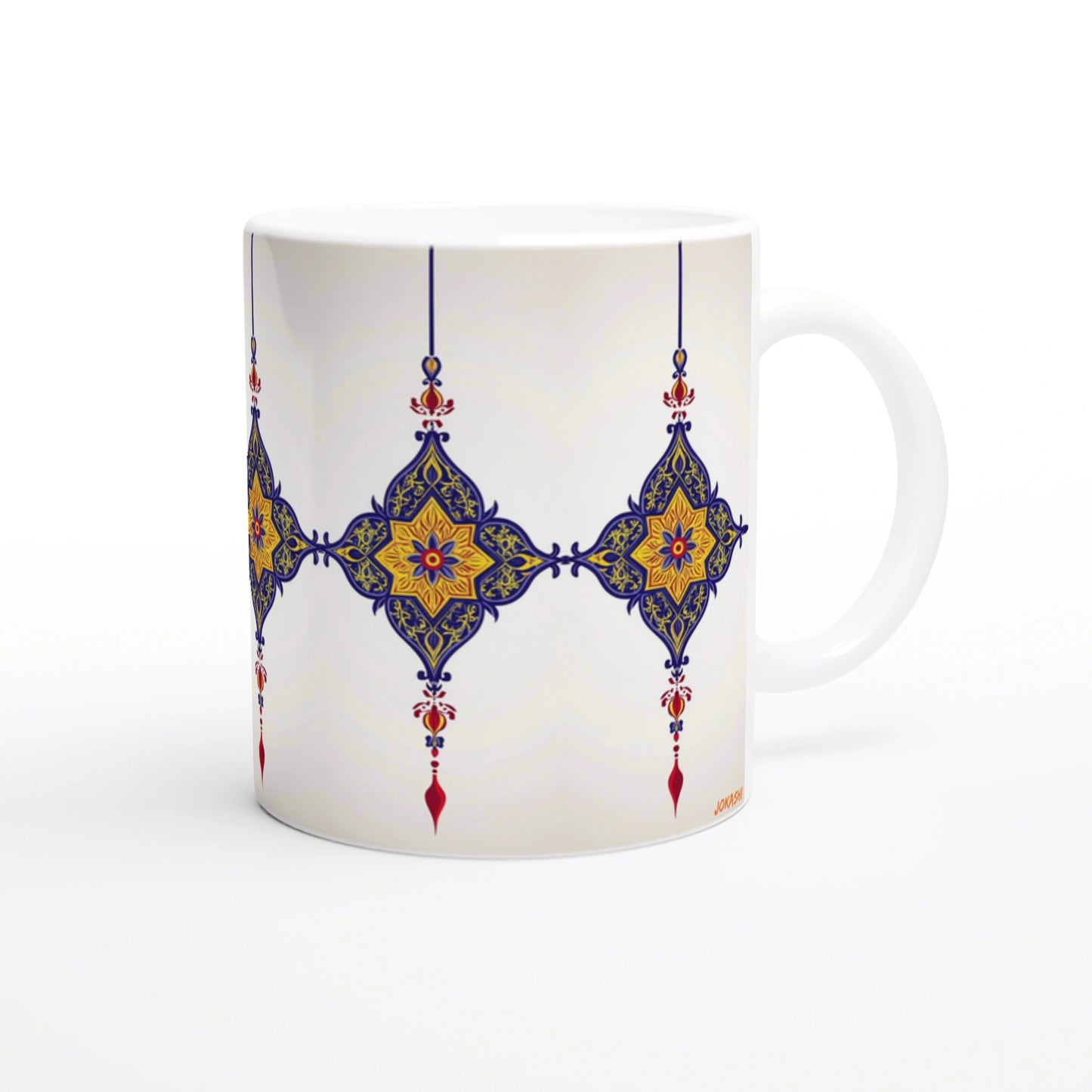 White ceramic mug with a blue and gold ornate geometric tile pattern and red accents.