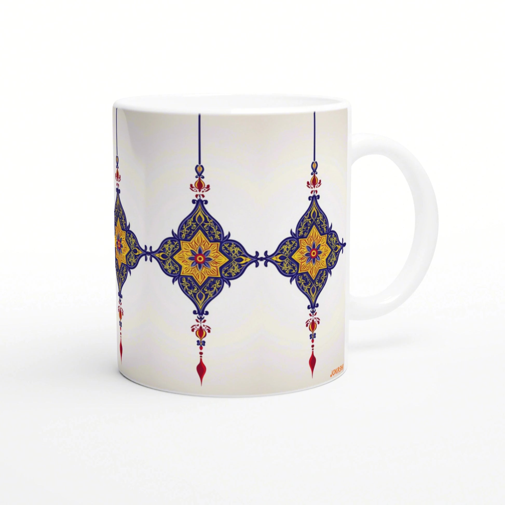 White ceramic mug with a blue and gold ornate geometric tile pattern and red accents.
