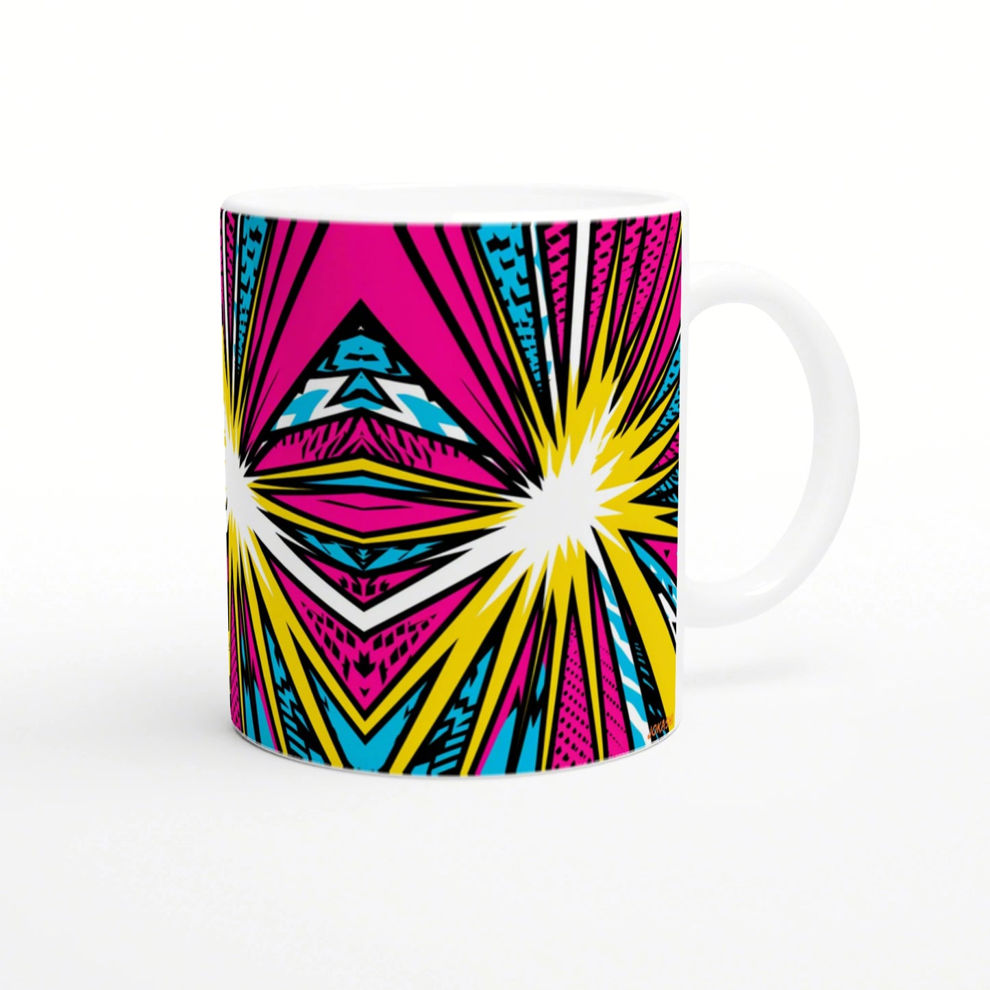 White ceramic mug with bold pop-art pattern in pink, yellow, cyan and black; geometric starbursts across the surface.