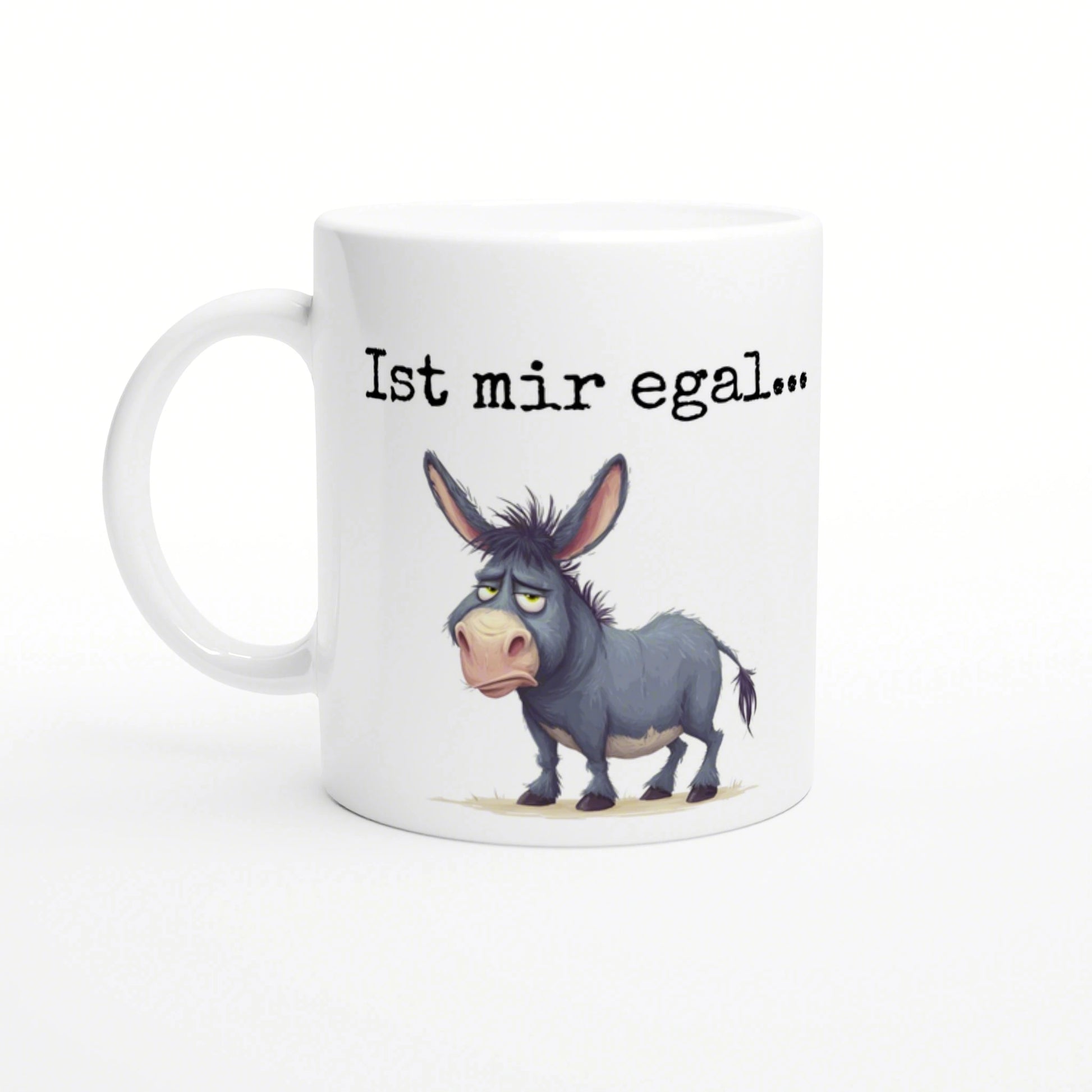 White ceramic mug with a cartoon blue-gray donkey and the phrase 'Ist mir egal...' in black typewriter-style text.