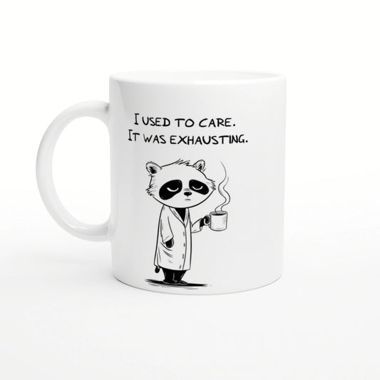 White ceramic mug with a cartoon panda in a robe, holding a steaming mug and the caption 'I used to care. It was exhausting.'