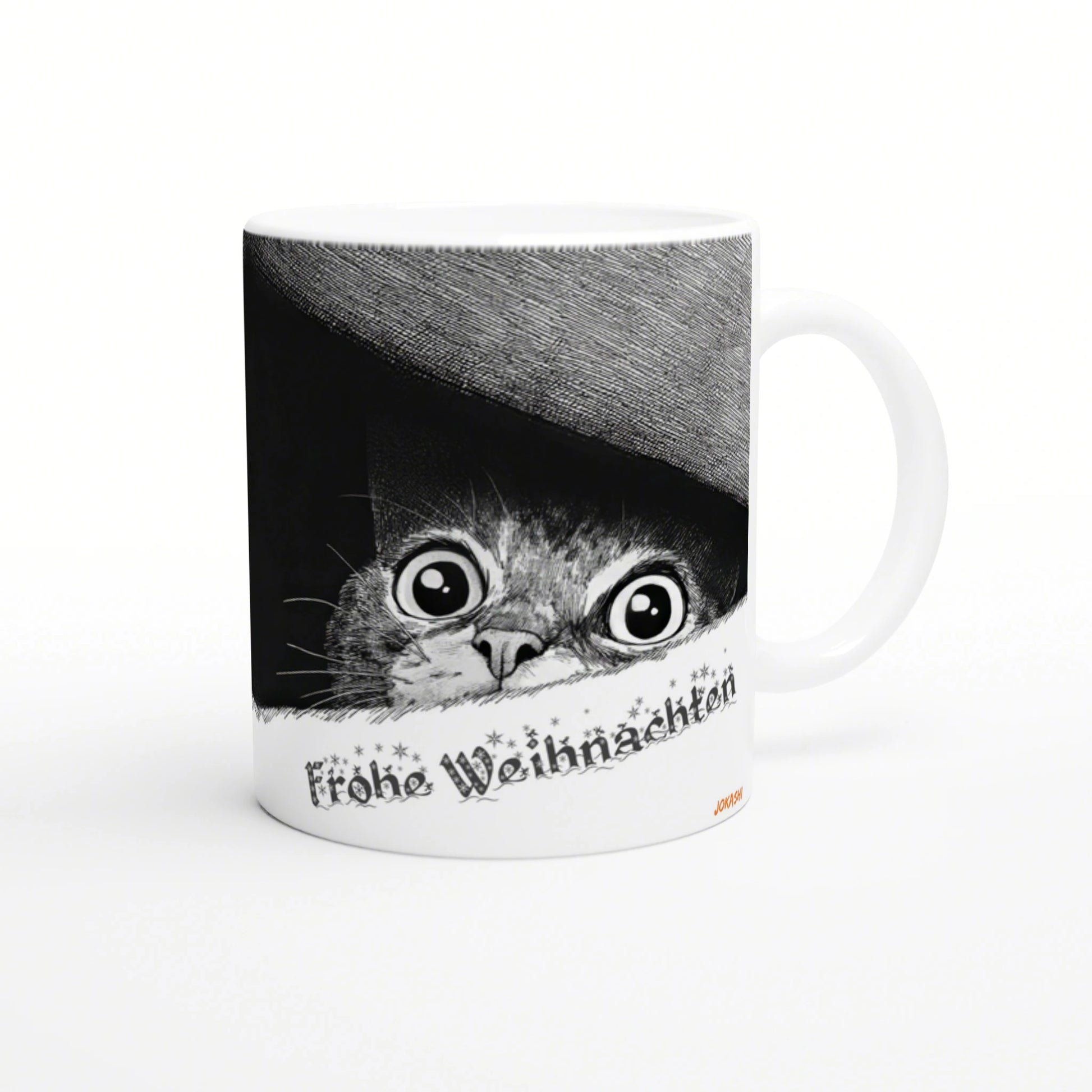 White ceramic mug with a black-and-white illustration of a wide-eyed cat peeking from under a hat and Frohe Weihnachten text.