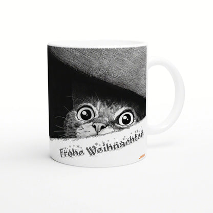 White ceramic mug with a black-and-white illustration of a wide-eyed cat peeking from under a hat and Frohe Weihnachten text.