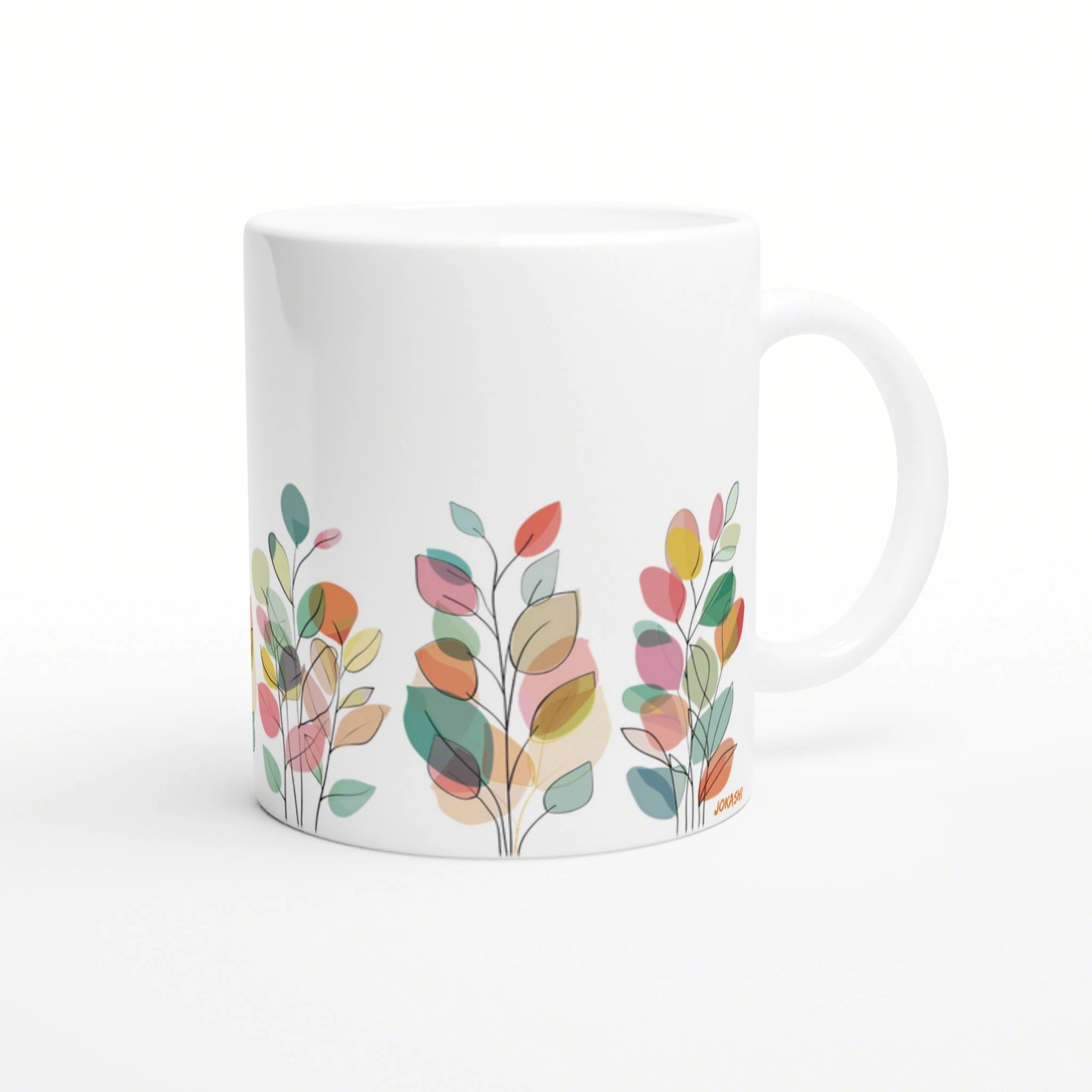 white ceramic mug with a colorful abstract leaf pattern along the bottom edge; product mockup.