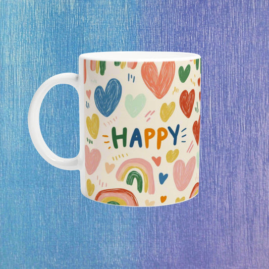 White ceramic mug with colorful hearts and the word HAPPY on a cream background; playful product mockup.