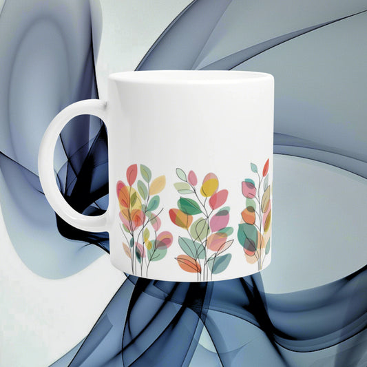 White ceramic mug featuring a colorful leafy floral pattern around the base; product mockup on abstract blue background.