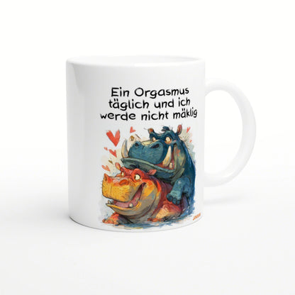 White ceramic mug with a playful illustration of two cartoon dinosaurs — blue on top of orange — surrounded by hearts and a bold German slogan.