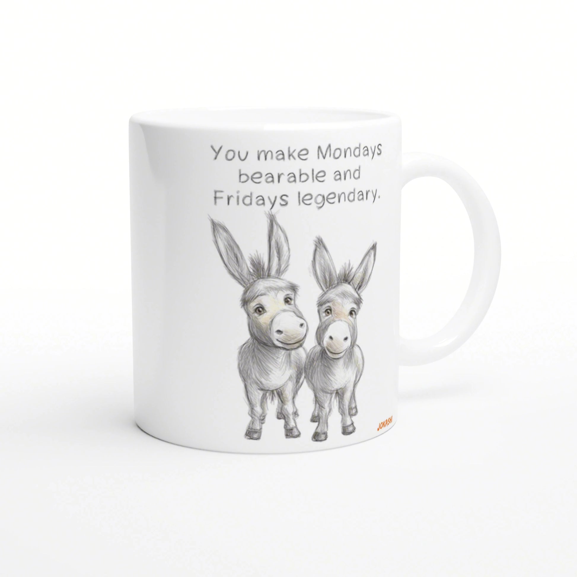 White ceramic mug mockup with a pencil sketch of two donkeys and the slogan You make Mondays bearable and Fridays legendary.