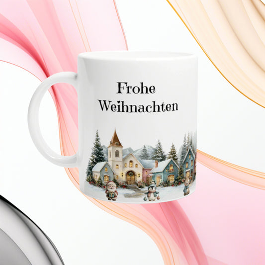 White ceramic mug featuring Frohe Weihnachten text and a snowy village illustration at the bottom, festive product mockup.