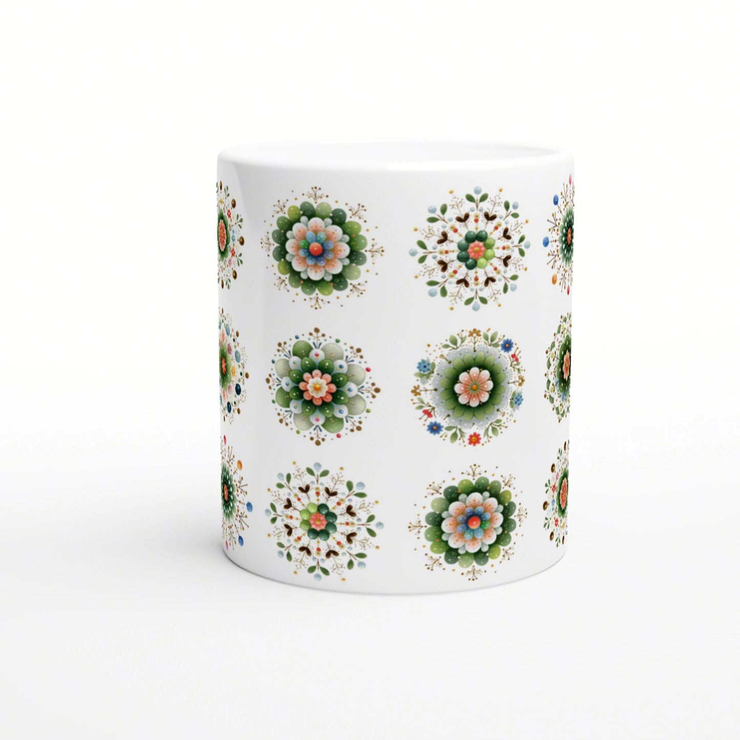 White ceramic mug with repeating colorful floral mandala patterns on a white background; product mockup.