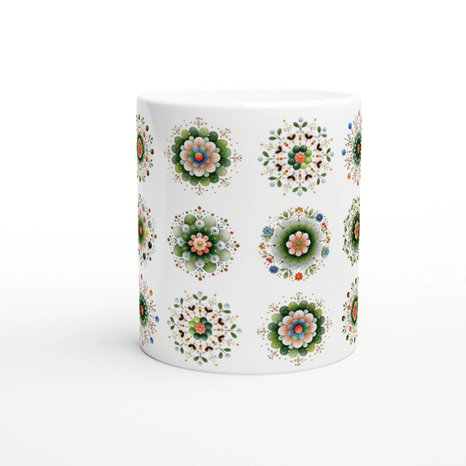 White ceramic mug with repeating colorful floral mandala patterns on a white background; product mockup.