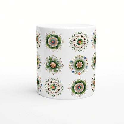 White ceramic mug with repeating colorful floral mandala patterns on a white background; product mockup.
