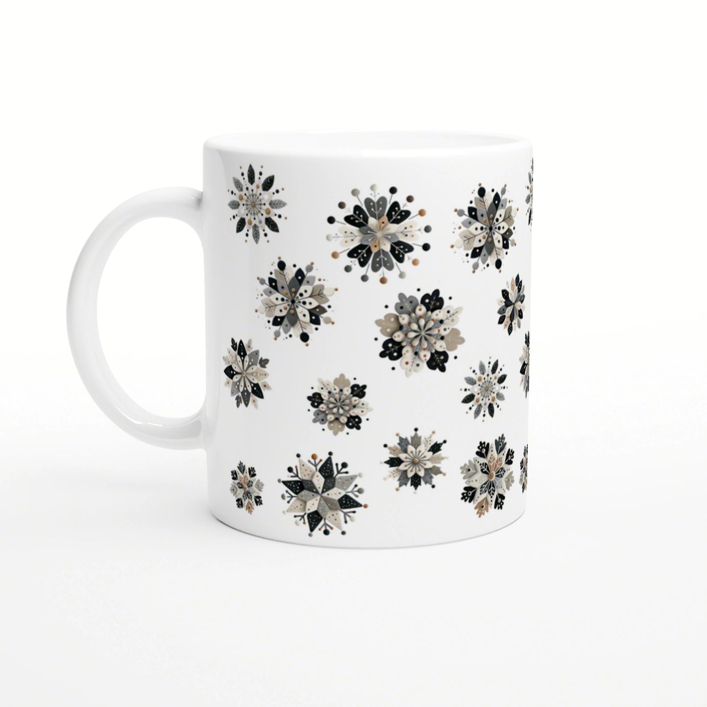 White ceramic mug featuring scattered black, beige and gray floral snowflake patterns; product mockup.